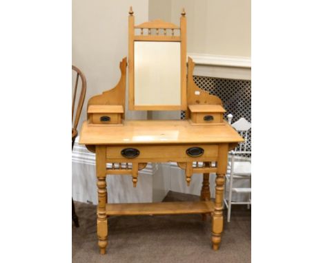 A Victorian Pine Dressing Table, late 19th century, with pivoting mirror and two small drawers, the base with a long frieze d