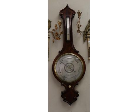A Mahogany Wheel Barometer, signed E.S.Comberbach, Blackburn, circa 1850, well figured case with thermometer box, 12-inch sil