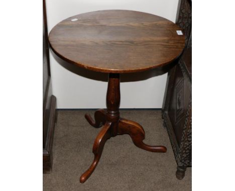 A George III Oak Circular Tripod Table, late 18th century, raised on a baluster support with three cabriole legs and pad feet