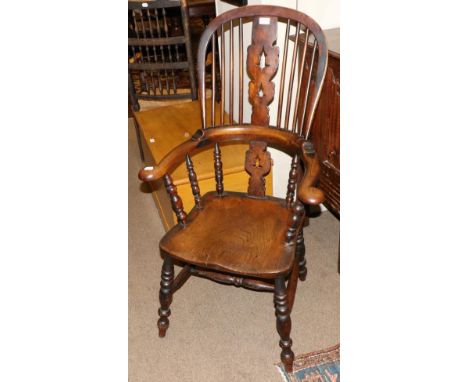 A 19th Century Ash and Beech Smoker's Bow High Back Armchair¸ with double pierced splat, ring turned supports and moulded sea