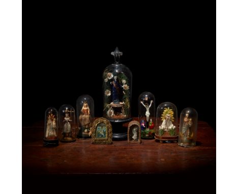 A collection of German blown glass and wax saints Most 19th/early 20th century Comprising three depictions of Virgin and Chil