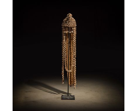 A Fang headdress Gabon Leather, cowrie shell and vegetal binding, with a cone shaped finial and long strands of shells fallin