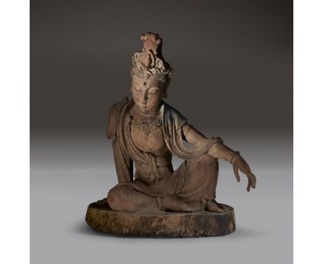 A Chinese carved and painted wood figure of Guanyin Ming dynasty or earlier Depicted sitting in rajalilasana, the ‘posture of
