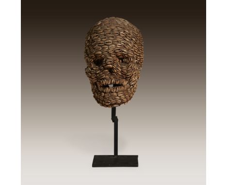 A grasslands model skull Cameroon Carved wood and cowrie shell, modelled in the form of a small human skull and entirely cove