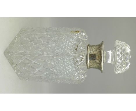 A silver rimmed cut glass decanter