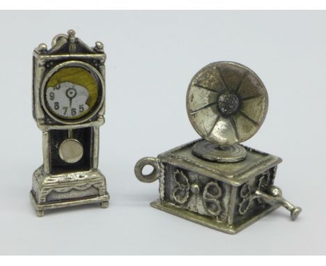 A silver longcase clock and a silver gramophone, 17g