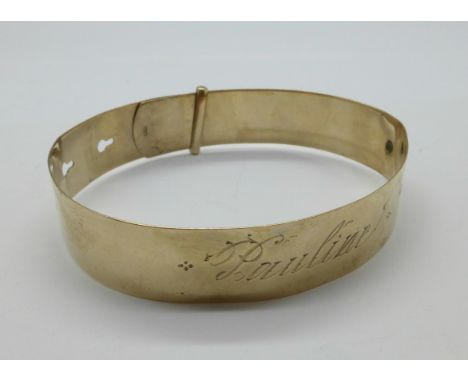A 9ct gold bangle with inscription, 13.2g