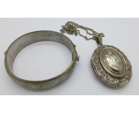 A silver bangle and a silver locket on chain