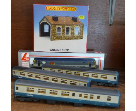 A Lima Rail Freight Distribution engine, three carriages, a Hornby engine shed and track