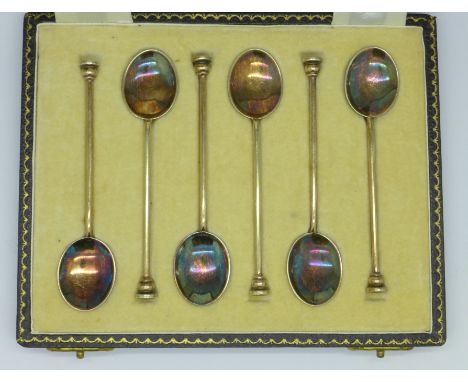 A cased set of six silver and enamel coffee spoons, enamel on two a/f, red and blue