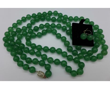 A jade coloured bead necklace and a pair of matching earrings