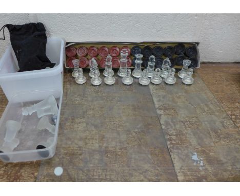 A glass chess set, one other chess set and Chad Valley Arbonite draughts pieces, boxed