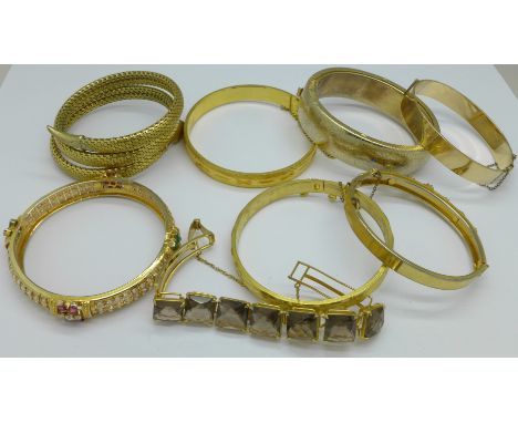 Seven bangles including a snake bangle and a bracelet, (8)