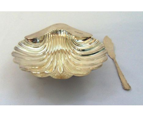 A late Victorian hallmarked silver shell shaped butter dish Sheffield 1896 and a hallmarked silver butter knife, approx total
