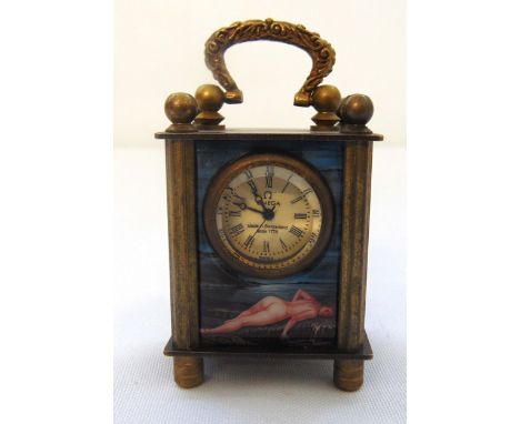 An Omega miniature carriage clock, the enamel side panels with erotic nude female figures and gilt metal carrying handle, 7 x