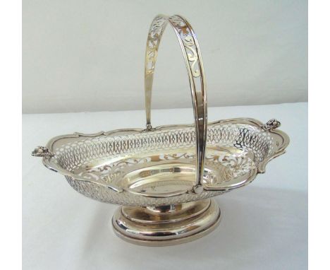 A hallmarked silver shaped oval pierced bread basket with swing handle on raised oval base, Sheffield 1914 by Walker and Hall