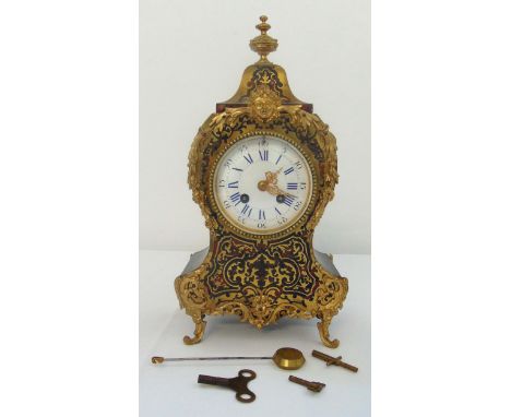 A Boulle mantle clock, of traditional form with white enamel dial and blue Roman numerals, two train movement, to include key