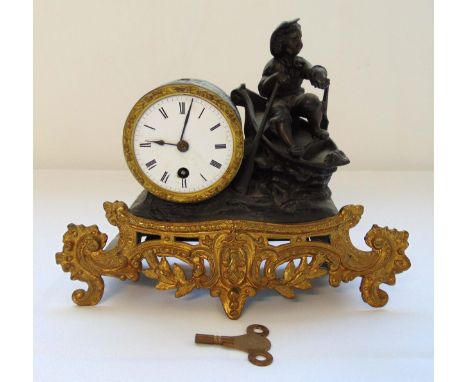 A late 19th century French mantle clock white enamel dial with Roman numerals flanked by a figure in a rowing boat, all mount
