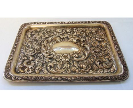 A hallmarked silver rounded rectangular dressing tray chased with flowers, leaves and scrolls, Birmingham 1902, approx total 
