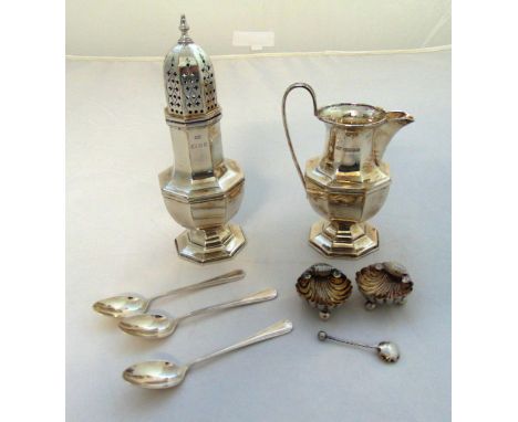 A quantity of hallmarked silver to include a sugar sifter, a cream jug, two shell shaped salts and a condiment spoons and thr