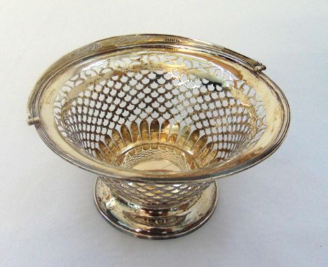 A Victorian hallmarked silver circular pierced bonbon basket with swing handle on raised circular base Birmingham 1899, appro
