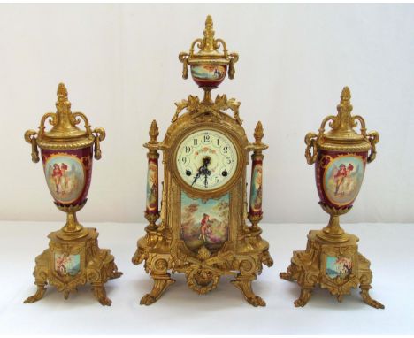 A late 19th century mantle clock gilded metal with porcelain panels flanked by two garnitures, 41.5 cm (h)