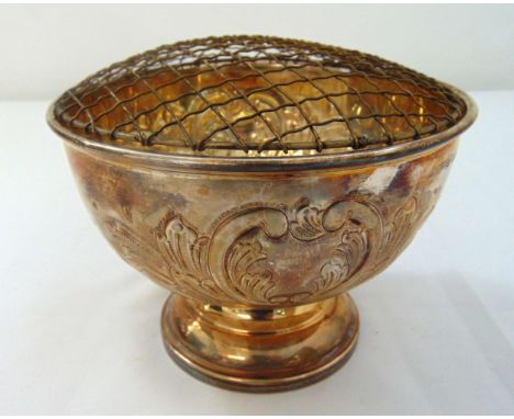 A hallmarked silver rose bowl chased with flowers, leaves and scrolls on raised circular base, Birmingham 1973, approx total 