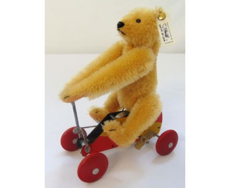 Steiff Ur Teddy 1926 sitting on a wind up metal scooter with wooden wheels, 1993 replica limited edition museum collection wh