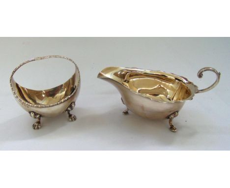 A hallmarked silver sauce boat with scroll handle Chester 1928 and a hallmarked silver bonbon dish in the form of a basket Bi