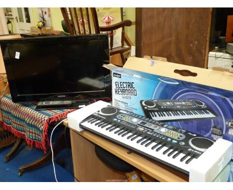 An electric keyboard and a "Panasonic'' TV 24" screen and remote.