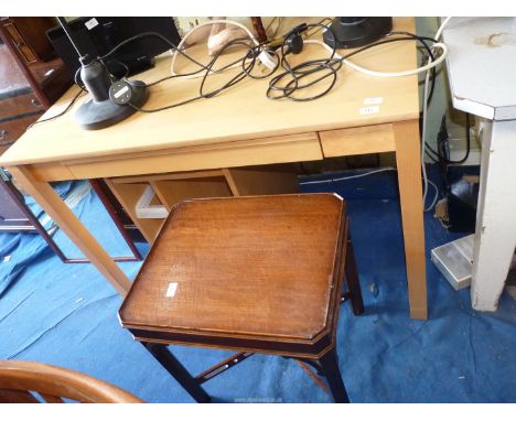 A modern light-wood table/desk,a shelf unit on castors and a small square Mahogany occasional table.