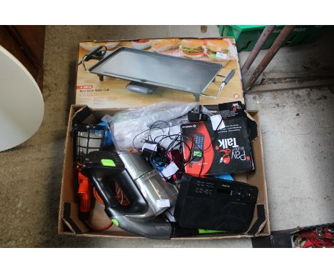 A non stick grill table, camping stoves. G-Tec with charger, Play as you talk phone.