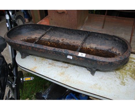 A cast iron pig trough/planter, 35" long x 12" x 6" high.