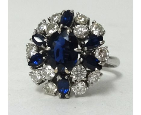 An 18ct white gold sapphire and diamond cluster ring, ring size N1/2