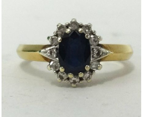 A 9ct gold sapphire and diamond cluster ring.