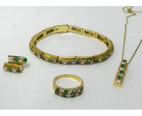 A suite of jewellery, comprising white sapphire and emerald stones, bracelet, ring, pendant and a pair of earrings set in 14c