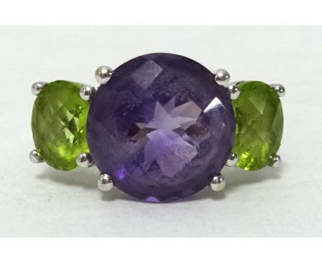 A 14k white gold amethyst and peridot ring, ring size N1/2