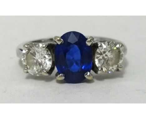 A fine 18ct white gold sapphire and diamond three stone ring, with original receipt dated 2003 for £4,200, ring size L