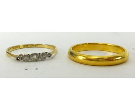 A 22ct gold wedding band together with a 18ct gold ring set with five small diamonds (weight of wedding band 4.90gms) (2).