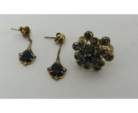 A 14ct dress ring set with a sapphire together with a pair of sapphire and diamond set drop pendant earrings in yellow metal.