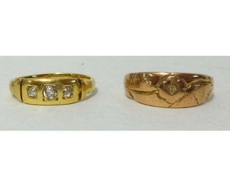 An antique yellow metal ring, another yellow metal and three stone diamond set ring (no hallmarks), (2), approx 6.3gms.