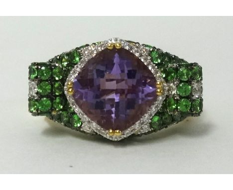 An 18ct amethyst, diamond and green garnet set dress ring, finger size O.