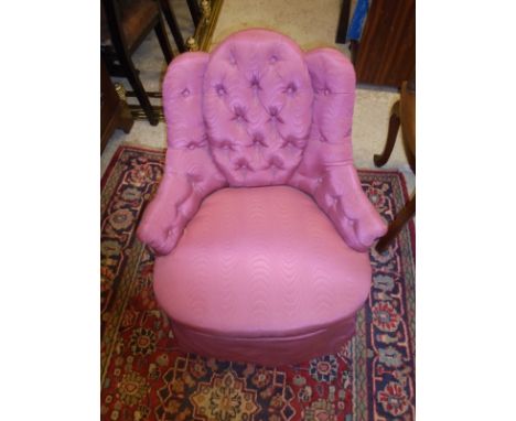 A pink upholstered button back bedroom chair, raised on mahogany turned legs to brown china castors