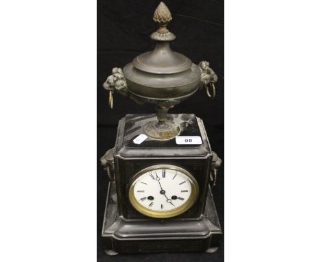 A Victorian black slate cased mantle clock with lion mask ring decoration and large urn finial with cover, the 8-day movement