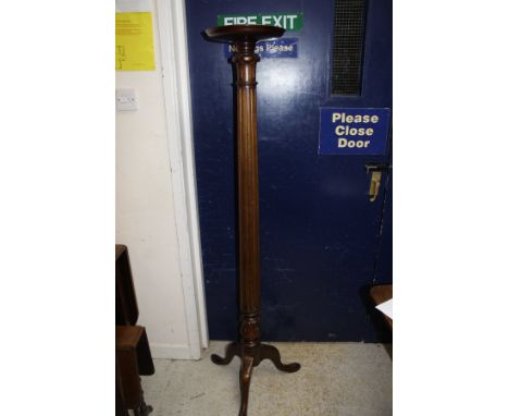 A 19th Century mahogany torchere, the circular dished top raised on fluted column support to tripod base