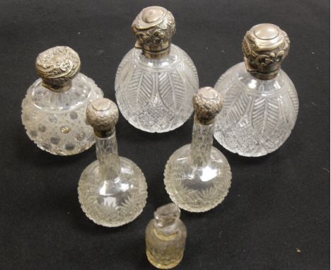 A pair of silver mounted and lidded cut glass grenade scent bottles (by W & G Neal, London 1895), together with a pair of sil