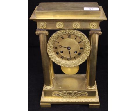 A French Regency period lacquered brass cased mantle clock with Ionic column supports, the eight day movement with circular e