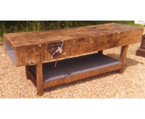 A pine top workbench with integral vice, raised on rectangular section legs and united undertier   CONDITION REPORTS  Has bee