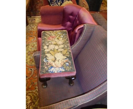 A 19th Century armchair in a red ground and blue patterned upholstery, raised on mahogany square section tapering supports to
