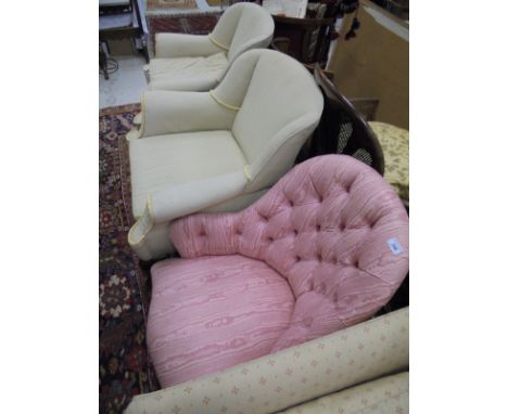A Victorian salon chair in a pink button back upholstery stood upon mahogany turned and carved front legs, together with two 